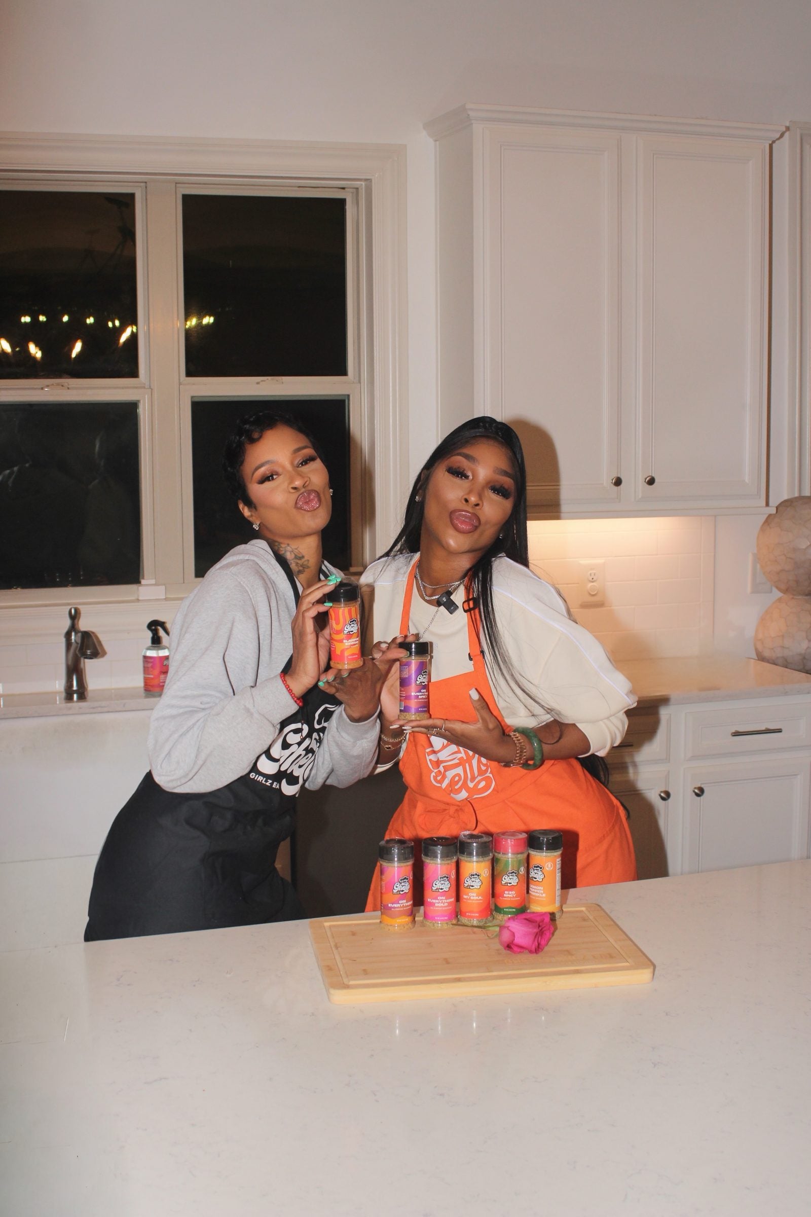 Two women in the kitchen with SiFood seasoning jars